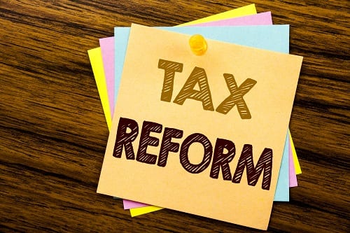 Conceptual hand writing text caption inspiration showing Tax Reform. Business concept for Government Change in Taxes written on sticky note paper on the wooden background.